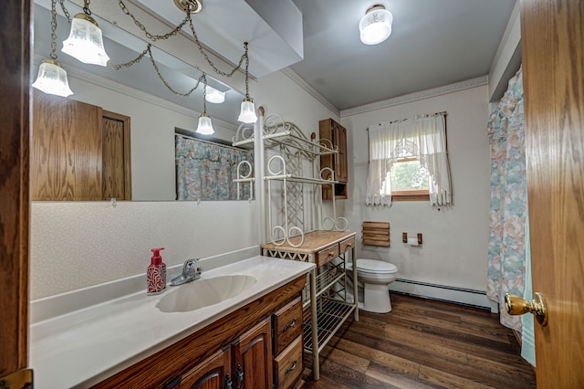 bathroom with ornamental molding, vanity, baseboard heating, hardwood / wood-style floors, and toilet