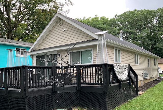 back of house with a wooden deck