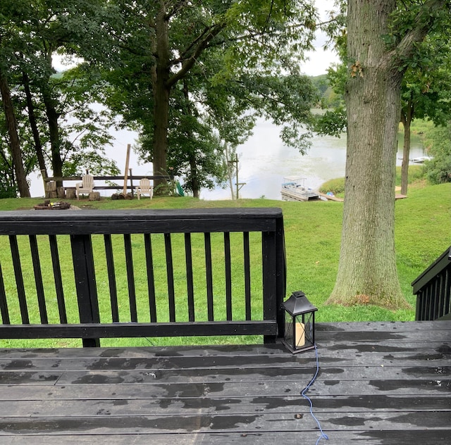 wooden terrace featuring a yard and a water view