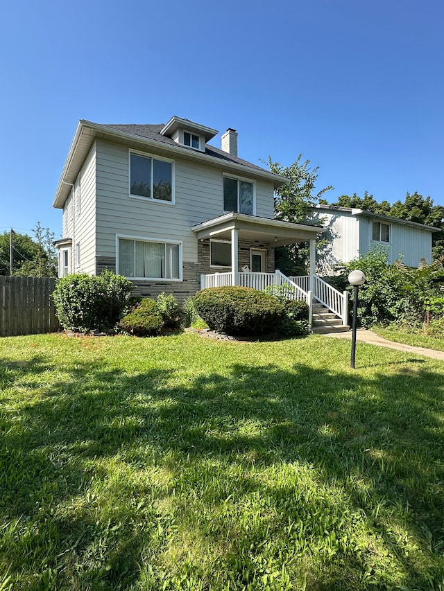 view of front of house with a porch and a front yard