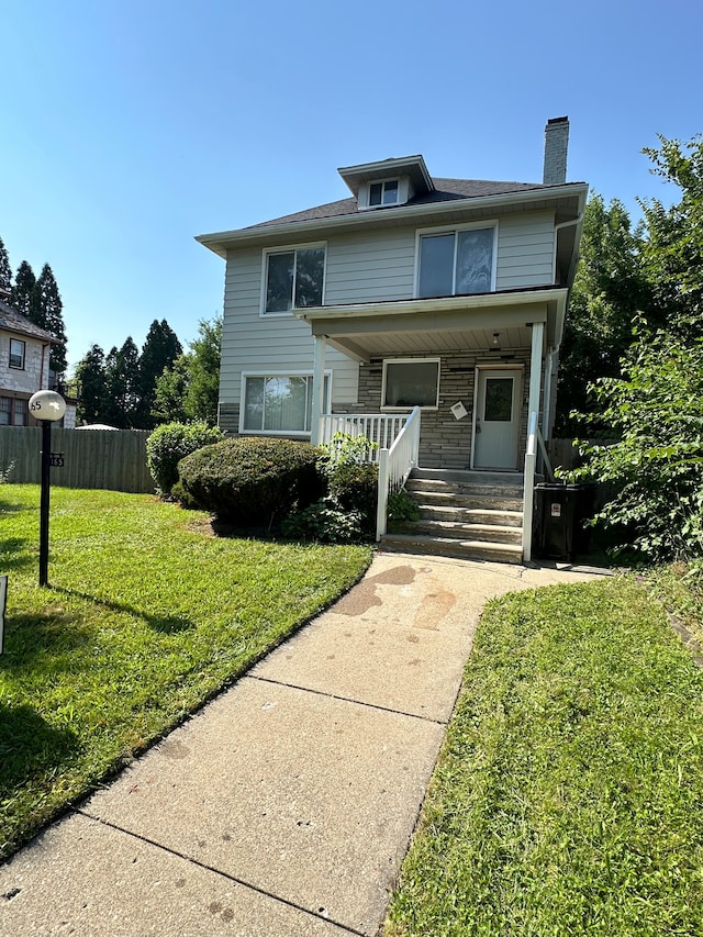 view of front of home with covered porch and a front yard