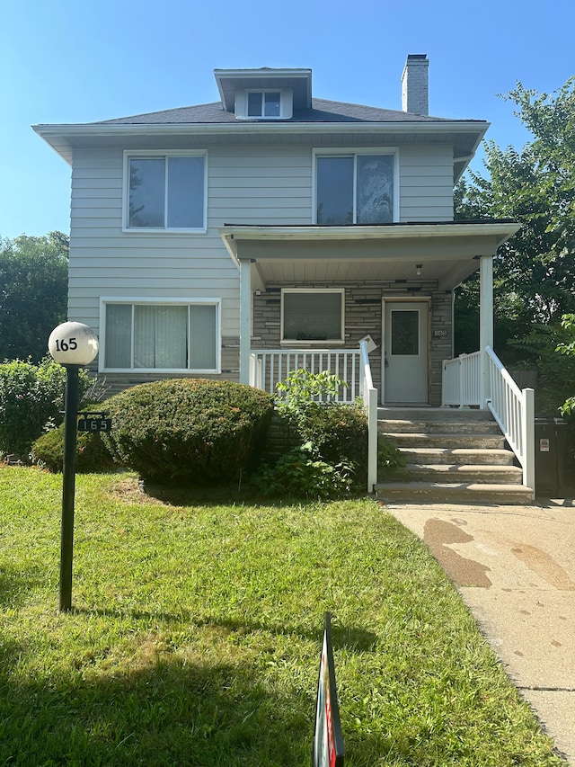 view of front of house with a front lawn and a porch