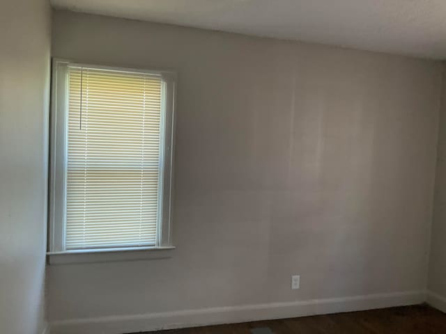 unfurnished room featuring dark hardwood / wood-style floors