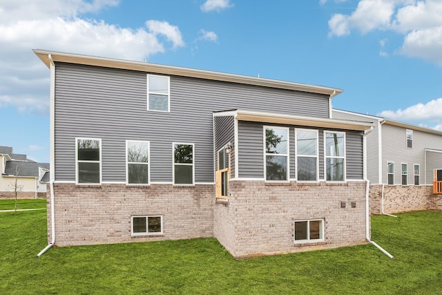 rear view of house featuring a yard