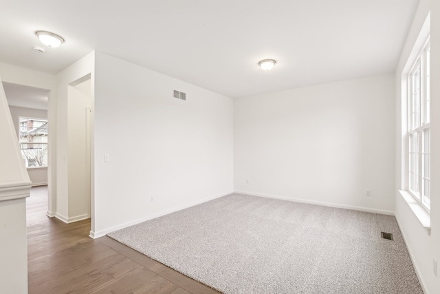 empty room with hardwood / wood-style flooring