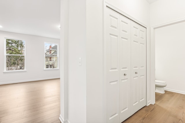 corridor with light hardwood / wood-style floors