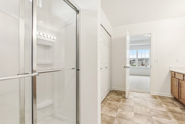 bathroom featuring walk in shower and vanity