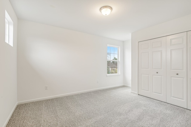 unfurnished bedroom with a closet and carpet flooring