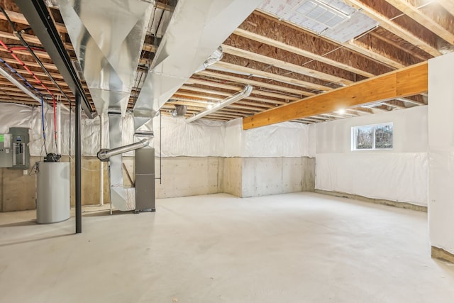 basement with heating unit, gas water heater, and electric panel