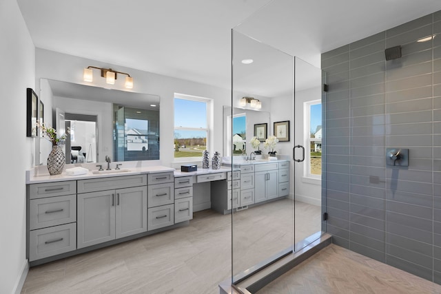 bathroom featuring plenty of natural light, vanity, and a shower with door