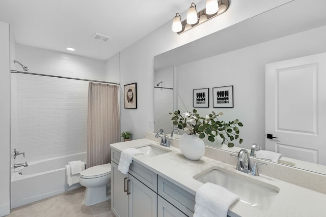 full bathroom with tile patterned flooring, vanity, toilet, and shower / bath combo with shower curtain