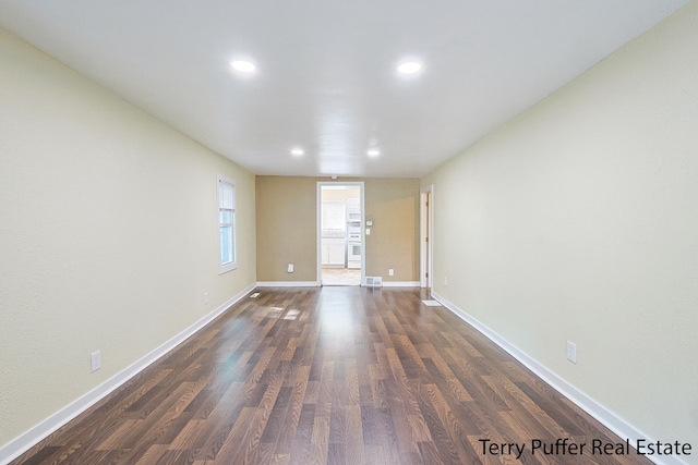 empty room featuring dark wood-type flooring