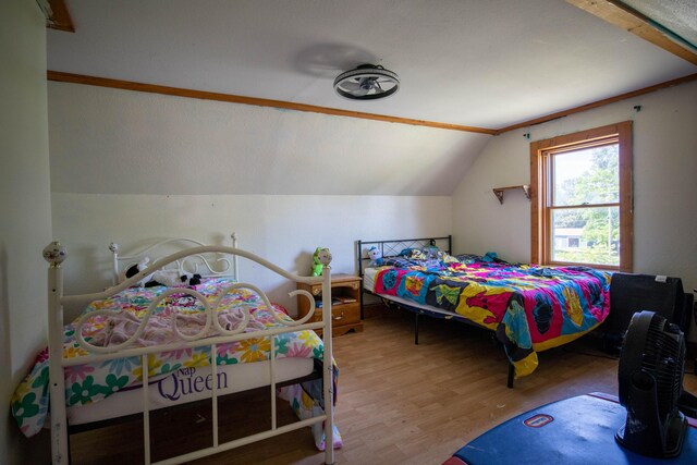 515 Locust St, Howard City, MI 49329 - bedroom featuring wood finished floors and vaulted ceiling