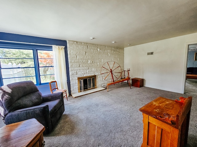 living room featuring carpet flooring and a fireplace