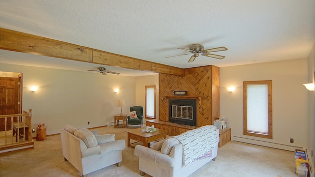 living room featuring a textured ceiling, light colored carpet, baseboard heating, and a large fireplace