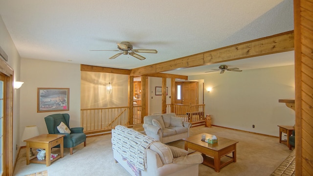 living room with a textured ceiling, light colored carpet, and ceiling fan