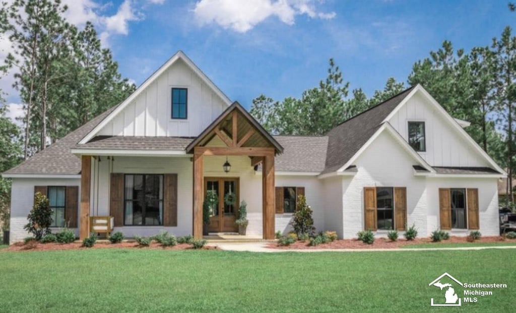 modern inspired farmhouse with a front lawn