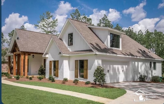 view of front of home with a garage and a front lawn