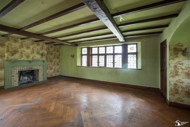 1989 W Grand Blvd, Detroit, MI 48208 - unfurnished living room featuring beam ceiling, a tiled fireplace, and baseboards