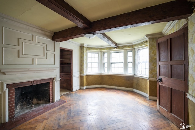 unfurnished living room with beamed ceiling, dark parquet flooring, crown molding, and a brick fireplace