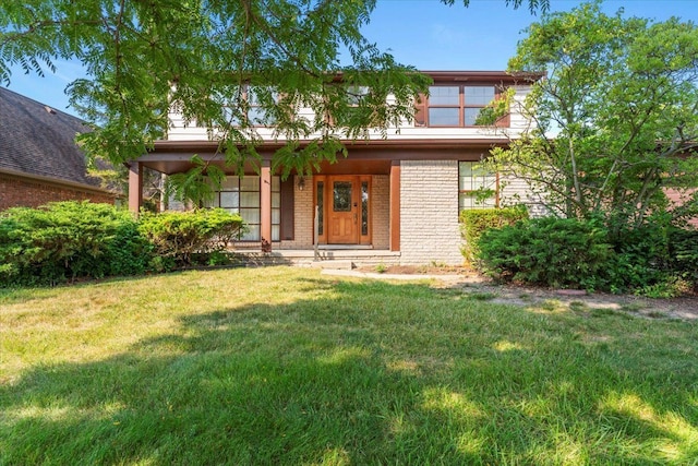 view of front facade with a front lawn and covered porch