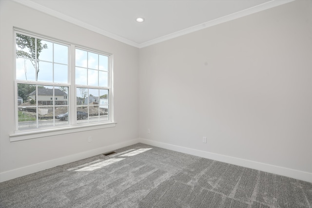 carpeted spare room with crown molding