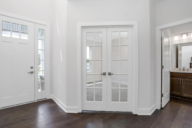 entryway featuring dark hardwood / wood-style flooring, sink, and french doors