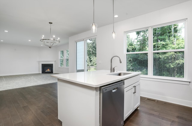 kitchen with dishwasher, a center island with sink, white cabinets, sink, and hanging light fixtures