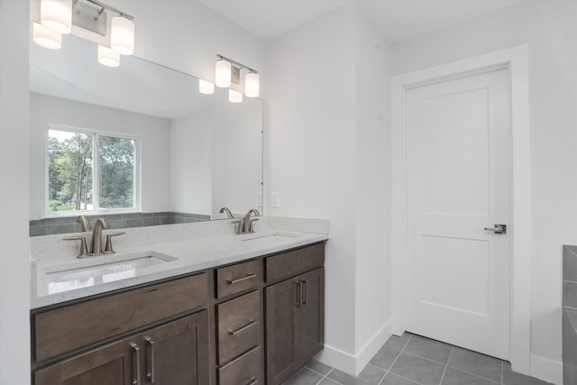 667 Allegheny Dr, South Lyon, MI 48178 - bathroom with double vanity, tile patterned floors, and baseboards