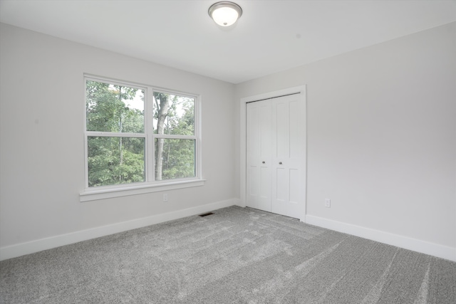 unfurnished bedroom with a closet and carpet