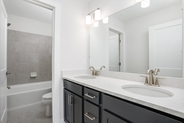 full bathroom featuring tile patterned floors, vanity, tiled shower / bath combo, and toilet