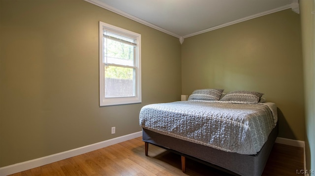 bedroom featuring hardwood / wood-style floors and ornamental molding