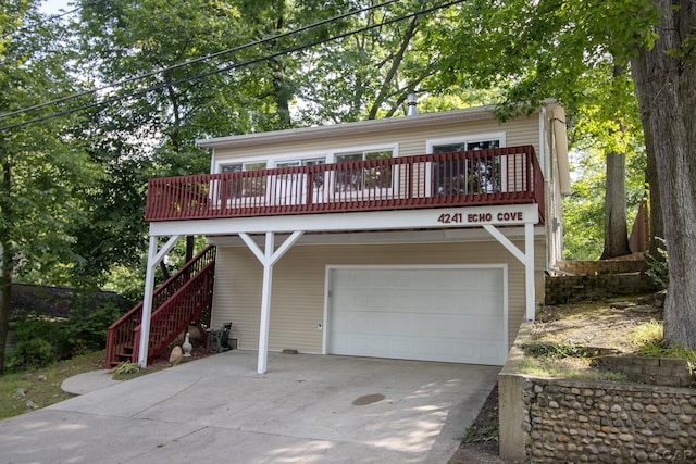 4241 Echo Cv, Manitou Beach, MI 49253 - view of front of property featuring a garage, concrete driveway, a wooden deck, and stairway