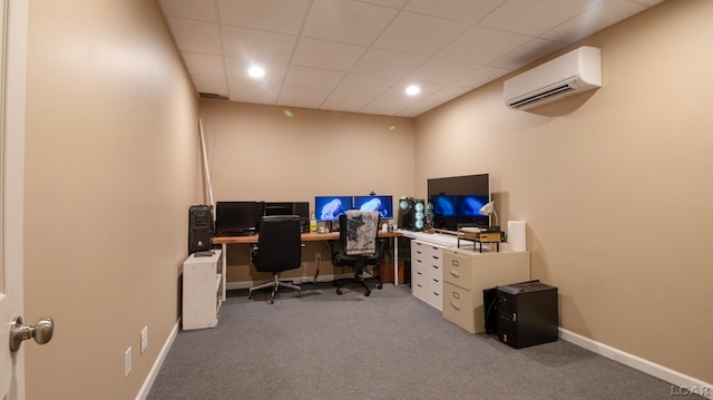 carpeted office space with an AC wall unit and a paneled ceiling