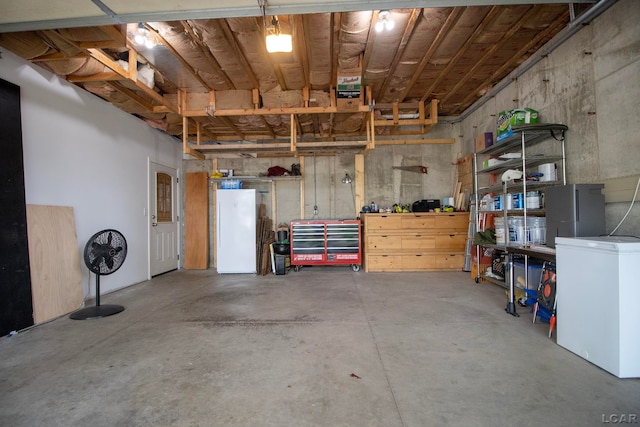 garage featuring fridge and white refrigerator