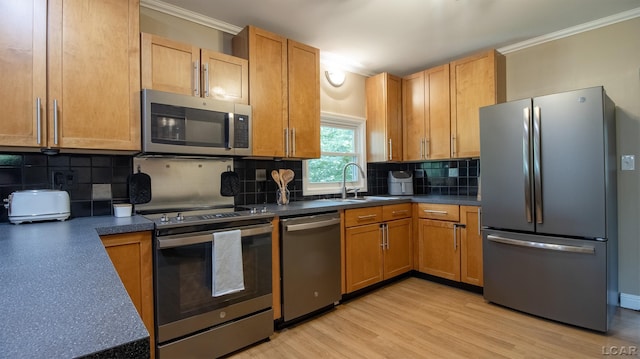 4241 Echo Cv, Manitou Beach, MI 49253 - kitchen with stainless steel appliances, a sink, ornamental molding, tasteful backsplash, and dark countertops