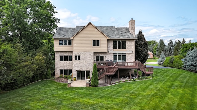 back of house with a deck and a yard