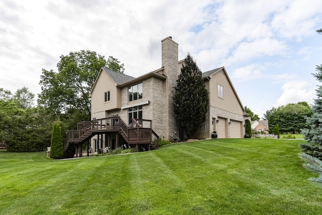 rear view of property featuring a yard, a garage, and a deck