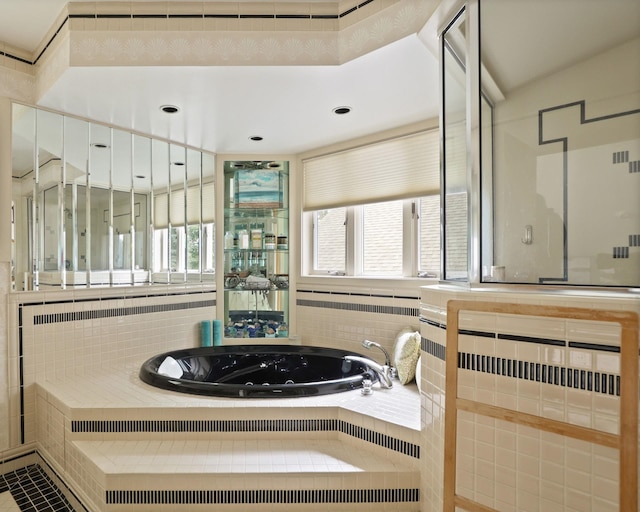 bathroom featuring tiled tub