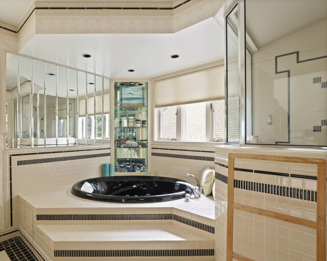 9300 Ormes Rd, Vassar, MI 49768 - bathroom with a whirlpool tub and tile walls