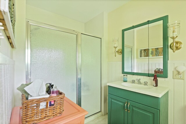 9300 Ormes Rd, Vassar, MI 49768 - bathroom with a stall shower, vanity, a wainscoted wall, and tile patterned floors