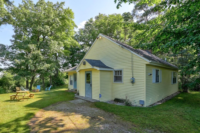 back of property featuring a yard