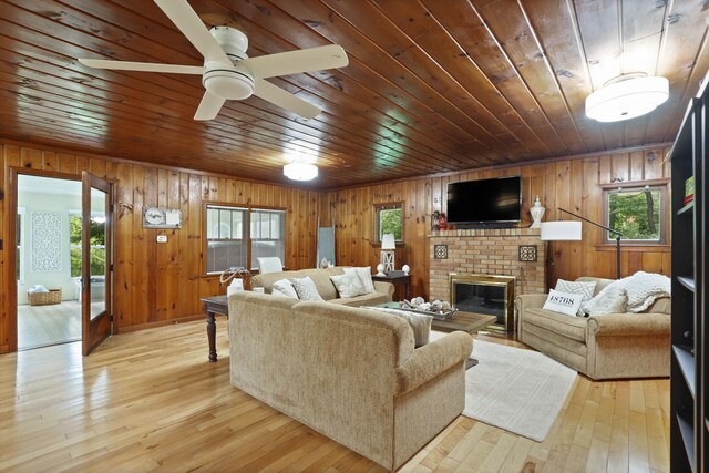 9300 Ormes Rd, Vassar, MI 49768 - living room with healthy amount of natural light, wooden ceiling, wood walls, a fireplace, and hardwood / wood-style floors
