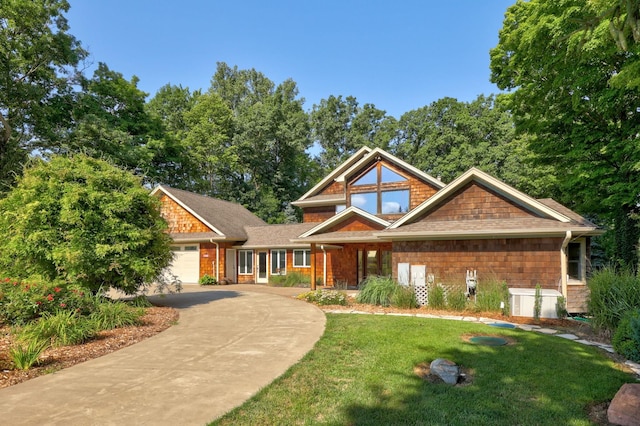 craftsman inspired home with a front yard and a garage