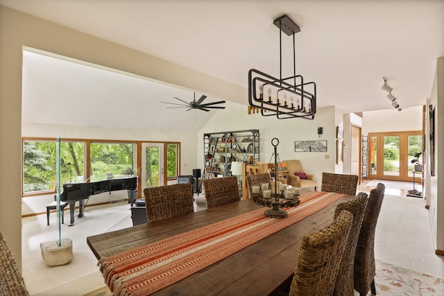 dining area with light carpet, french doors, track lighting, vaulted ceiling, and ceiling fan