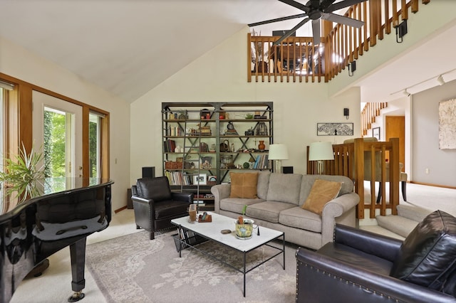 carpeted living room with ceiling fan and high vaulted ceiling