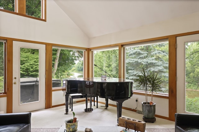 misc room with high vaulted ceiling, light colored carpet, and a wealth of natural light