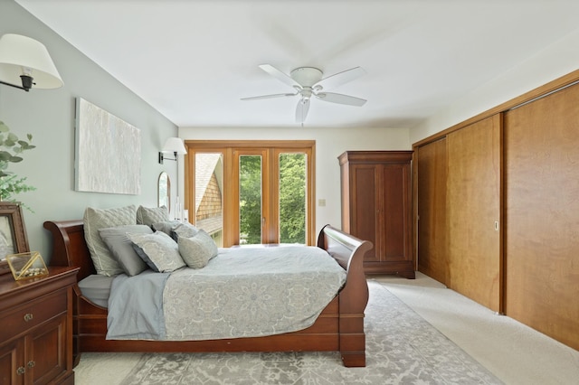 carpeted bedroom with ceiling fan and access to outside