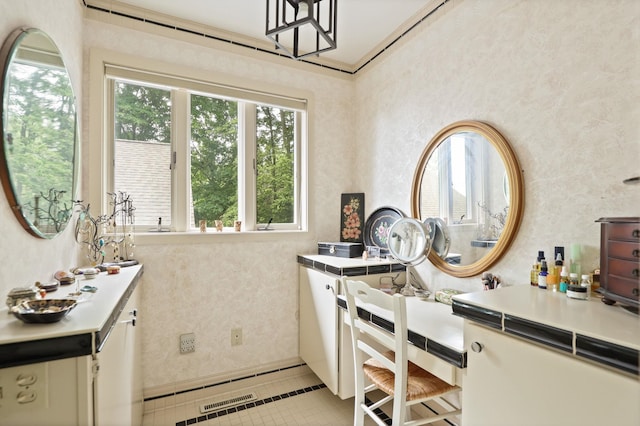 kitchen with light tile patterned floors, white cabinetry, and tile counters