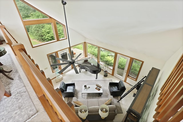 living room with carpet, a wealth of natural light, and high vaulted ceiling